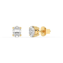 A pair of yellow gold stud earrings with oval laboratory-grown diamonds, displayed against a white background.